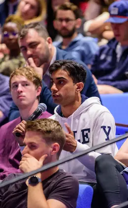 A student asking a question in an auditorium