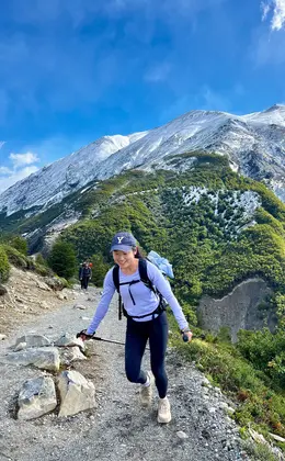 A person hiking in a Yale baseball cap