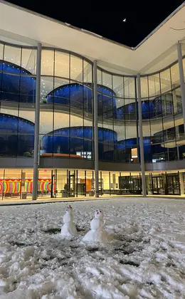 Two snowmen in the Shen Courtyard at Evans Hall 