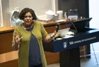 Professor at front of class, gesturing. Podium behind reads Yale School of Management.