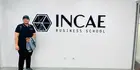 Talha Aamer Chaudry in front of a sign that reads INCAE Business School