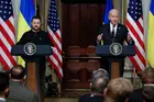 President Zelensky and President Biden standing at lecterns talking