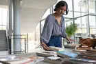 A student organizing a display of books on a table