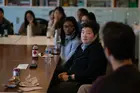 Students sitting at a table with Reddit COO Jen Wong