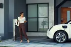 Marketing Insights to Expand into Electric Vehicles: A woman charging her electric vehicle in the comfort of her own home