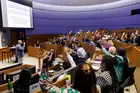 Classroom with student hands raised