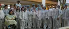 Group members gathered in personal protective equipment for a group photo