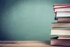 pile of books on a blue green background