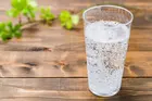 clear glass of seltzer water on wooden background