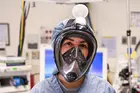 Healthcare worker wearing a snorkel mask converted to meet clinical specifications