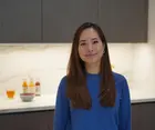 headshot of Tiffany Leong with beverages on a counter in the background