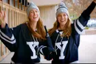 Students in hockey uniforms waving