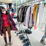 person browsing rack of clothes