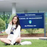 Fang Liu in front of Yale SOM Sign