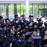 group of SOM students at Commencement in Evans Hall courtyard