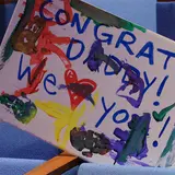 Handpainted sign saying" Congrats Daddy! We heart you"