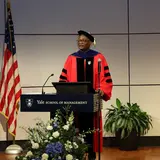 Dean Kerwin Charles addresses the group at the podium