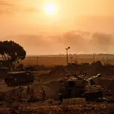 Soldiers from an IDF artillery unit stand ready near their position a few miles outside of Gaza, near Sderot, Israel