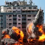 Landscape of buildings in Israel being bombed with fiery explosion