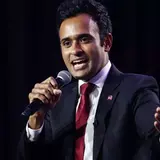 Vivek Ramaswamy holding a microphone while speaking