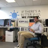 Laurence sitting at desk in KIPP DC office