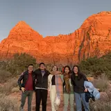 Group of friends outside in front of a mountain range