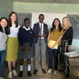 A group of MBA students posing with Kenyan students