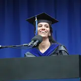 A graduating student speaking at a podium