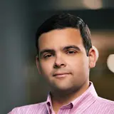 A person with short hair wearing a collared shirt