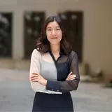 A person with folded arms and long hair