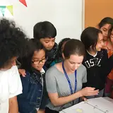 Adult surrounded by students